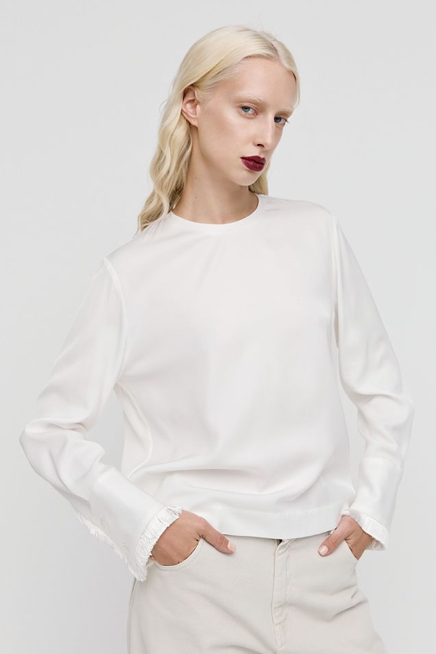 Off-white blouse embellished with small fringes